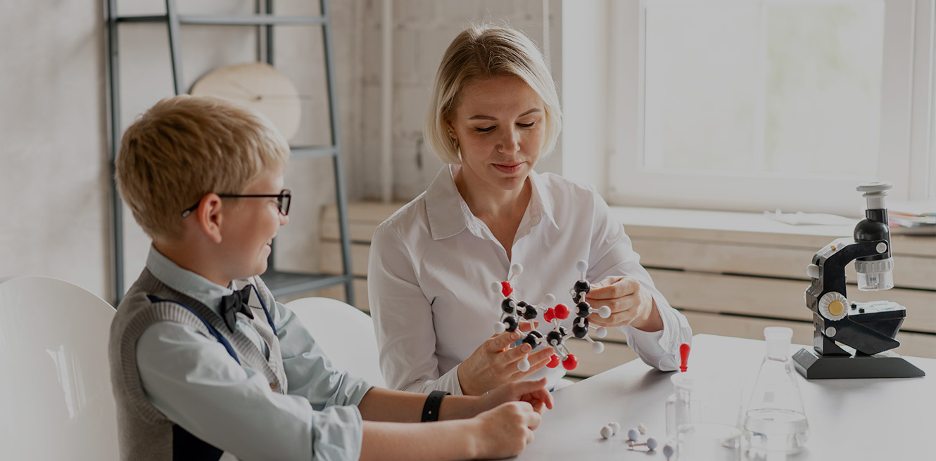 Female science tutor in Dayton studying chemistry with student